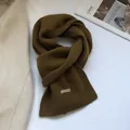 Detail of soft 100% Australian wool knit scarf in mustard yellow with woven label - Ginger Yellow