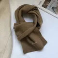 Detail showing 100% pure Australian wool scarf texture with material label in camel brown - Peanut Camel