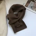 Detail view of 100% Australian wool scarf featuring dark brown knit texture and fabric label - Coffee