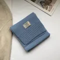 Detailed view of blue 100% Australian wool scarf with stitched fabric material label - Teal Blue