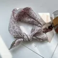 Detail of pink floral cotton linen scarf with green crochet lace edges on a magazine - 70*70cm / Pink