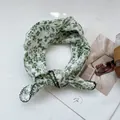 Detailed view of floral cotton linen scarf with green scalloped edges on white magazine - Green with Sunflower