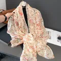 Detailed close-up of pink floral lightweight scarf with fringe edges and soft texture - 180x90cm / Off White