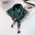 Detail of dark green equestrian print scarf with retro brown tassels on white background - Green Khaki Border