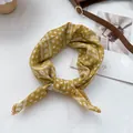 Detail of mustard yellow floral headscarf with delicate lace borders on a white fabric - 70*70cm / Yellow