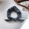 Close-up of a navy floral silk hair ribbon with knot detail on a white background - 58x58cm / Blue