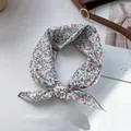 Close-up of floral print chiffon hair ribbon tied on a leather bag with magazine background - 58x58cm / White