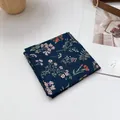 Detail of floral cotton linen headscarf showing fine stitching and dark blue print - Navy Blue Floral
