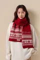 Detail of red and white Fair Isle knit scarf with 100% wool label and snowflake patterns - Red