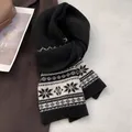 Detail of Fair Isle wool scarf with black and white snowflake patterns on a coat - Black
