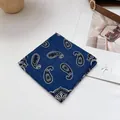 Detail of dark blue paisley cotton linen bandana with classic white pattern and stitching - Paisley Navy