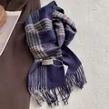 Detail of wool plaid scarf with fringes and brand label on a cozy winter coat - 180*30cm / Blue