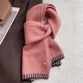 Detail of pink wool blend scarf showing soft knit texture and black striped hem finish - Korean Pink