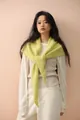 Detailed close-up of lime green knitted shawl with soft texture and front knot style - Light Lemon Yellow
