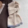 Detail of wool blend knitted scarf in cream with blue stripes and gold pendant charm - Cream Rice