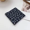 Detailed texture of navy floral cotton linen bandana with white leaf print and frayed edges - Leaf Black