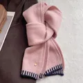 Detail of pink wool blend scarf showing soft texture and gold round pendant accessory - Pink