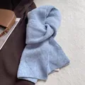 Detail shot of light blue wool knit scarf with soft diamond pattern and fuzzy texture - Blue