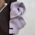 Detail showing 100% wool label on light purple knitted scarf with mélange effect - Taro Purple