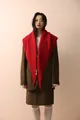 Detail of a bright red knitted shawl styled over a classic brown checkered blazer set - Red