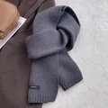 Detail showing the 100% wool knit texture and ribbed edge of the navy blue scarf - Dark Gray