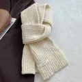 Detail of off-white thick knit wool scarf texture with elegant stitched brand label - Off White