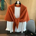 Detailed knit texture of burnt orange 100% wool triangle scarf on a white base layer - Bright Orange