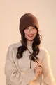 Close-up of dark brown ribbed knit trapper hat with protective ear flaps and ties - Ear Protection Style / Coffee