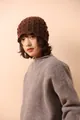Close-up of brown wool blend knit bucket hat featuring intricate hollow crochet design details - Caramel color