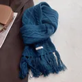 Close-up of dark blue 100% wool scarf with cable knit texture and fringe tassels detail - Navy Blue