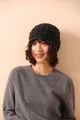 Detailed view of dark grey honeycomb crochet wool hat with scalloped edge texture - Black