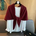 Detail of a deep red wool knit shawl knotted over a white long-sleeved shirt - Ancorra Red
