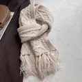 Detail of 100% wool cable-knit scarf with long fringe and high-quality material label - Off White