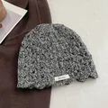 Detail showing high-quality 100% wool material and crochet knit texture on gray beanie - Gray