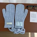 Detail of light blue chunky knit mittens with classic cable pattern and hanging neck cord - Cable Knit Neck Strap Style / Haze Blue