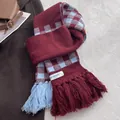 Detail shot of checkered knit scarf with tassels in burgundy and blue contrast - Ancorra Red