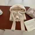 Detailed close-up of cream knit balaclava hood featuring ribbed texture and button closure - Off White
