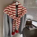 Detail of red and white striped knit shawl with fluffy pom-poms over a grey sweatshirt - Off White