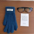 Detail of dark blue knit glove with brand label on rustic wood background - Azure Blue