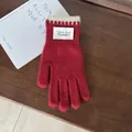 Detailaufnahme roter Strickhandschuhe mit Kontrastbündchen und minimalistischem Etikett - Rot