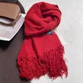 Detail of red tassel scarf with premium soft texture and warm knit material for winter - Red