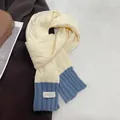 Close-up of cable-knit texture on beige and blue color-block winter scarf with tag - Beige & Blue