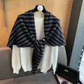 Detailed knit texture of a 100% wool striped shawl draped over a white crewneck sweater - Black and Gray