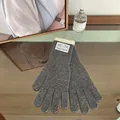 Detail of dark grey knitted gloves with cream ribbed cuffs and decorative brand label - Gray
