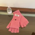 Detail of pink wool knit gloves featuring convertible fingerless flap and black button - Pink