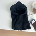 Flat lay of black knit balaclava hat with thick yarn texture and integrated neck warmer - Black