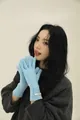 Detail of light blue merino wool gloves featuring a diamond knit pattern and woven tag - Azure Blue