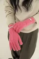 Detail view of pink merino wool knitted gloves with cable pattern and woven label - Pink