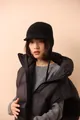 Detail of a black knit wool trapper hat with visor and long earflaps for winter - Black