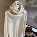 Detail of white chunky knit wool sweater with matching cable-knit scarf and chic layers - Off White